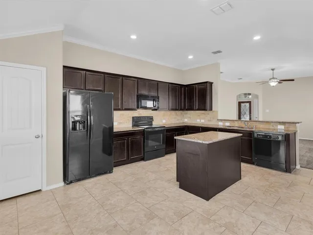 a large kitchen with cabinets and stainless steel appliances