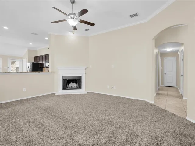 a view of an empty room with a fireplace