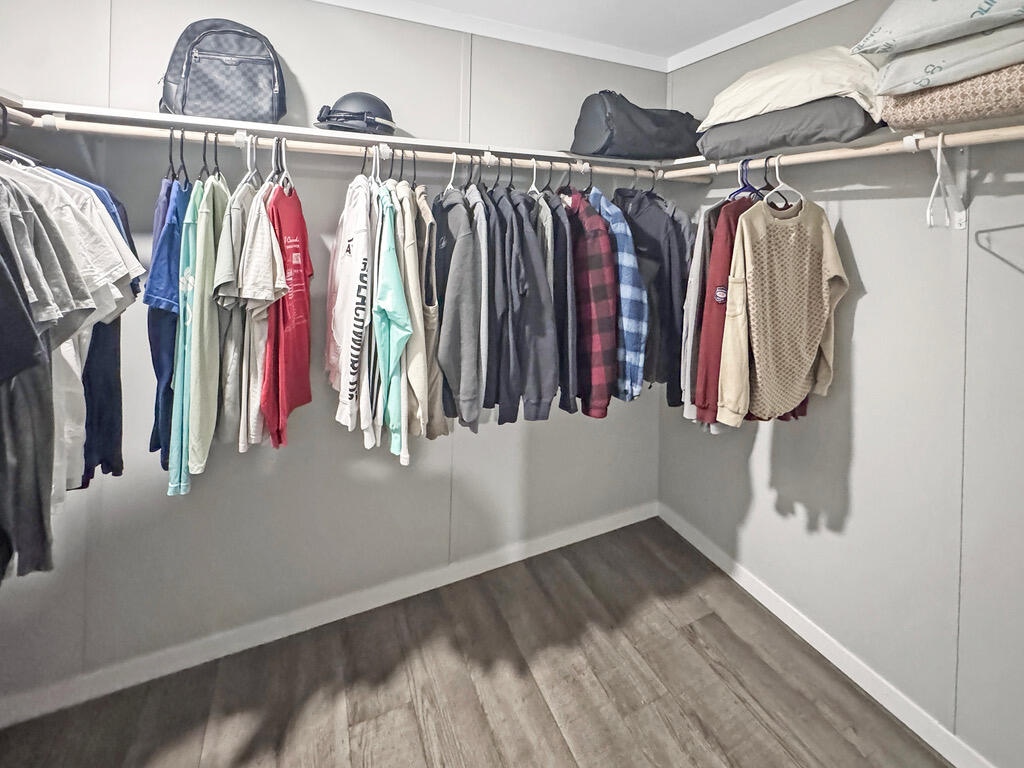 349 Private Road, Unit 243P Seminole, TX 79360 - Photo 17 of 24 a view of walk in closet with clothes