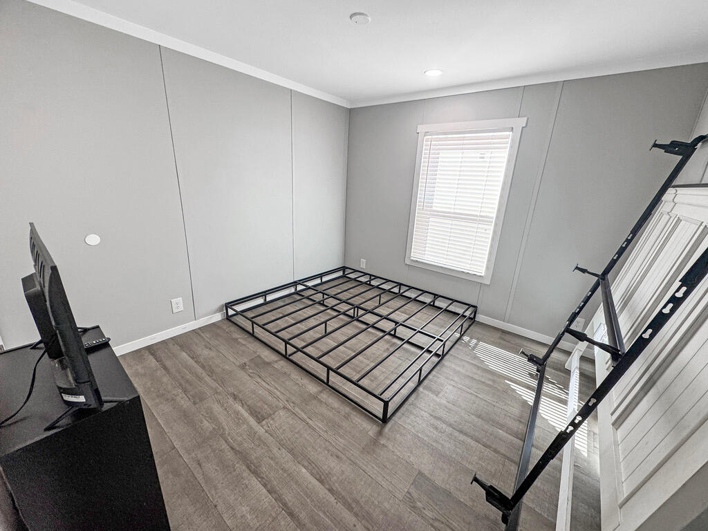 349 Private Road, Unit 243P Seminole, TX 79360 - Photo 20 of 24 a view of a room with wooden floor and stairs