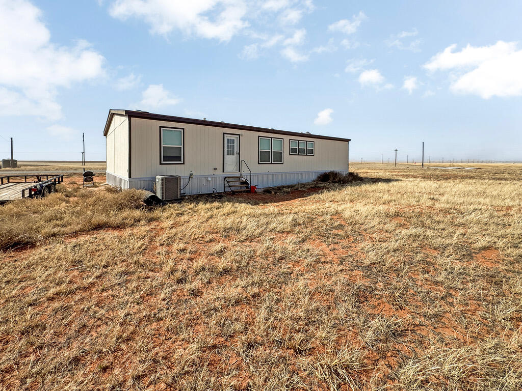 349 Private Road, Unit 243P Seminole, TX 79360 - Photo 23 of 24 a house view with swimming pool and sitting space