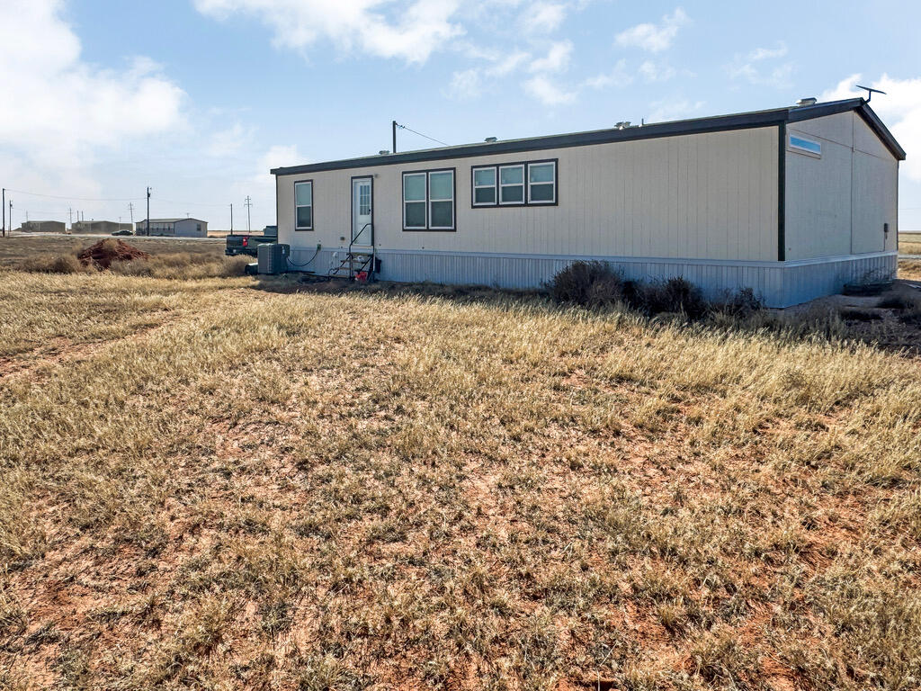 349 Private Road, Unit 243P Seminole, TX 79360 - Photo 24 of 24 a house view with a garden