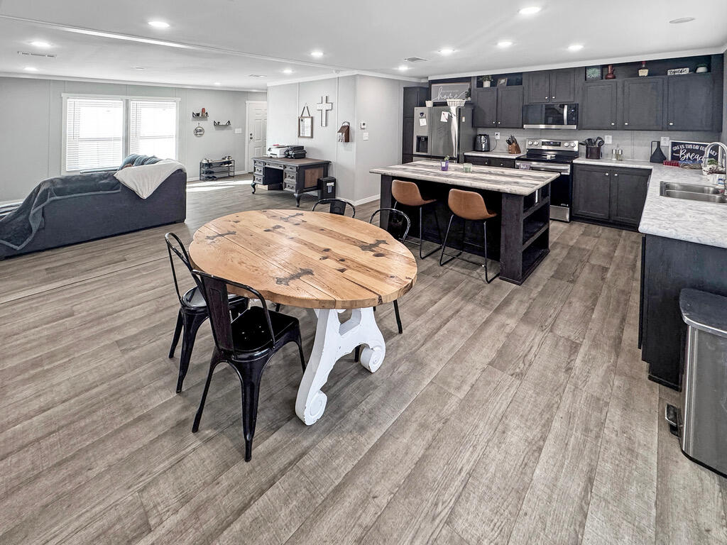 349 Private Road, Unit 243P Seminole, TX 79360 - Photo 5 of 24 a living room with stainless steel appliances furniture kitchen view and a wooden floor