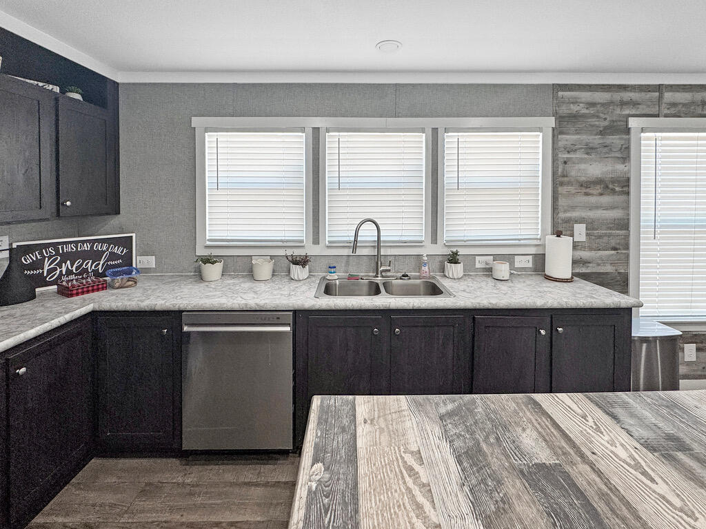 349 Private Road, Unit 243P Seminole, TX 79360 - Photo 7 of 24 a kitchen with a sink stove and cabinets