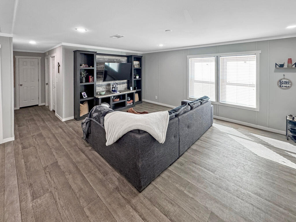 349 Private Road, Unit 243P Seminole, TX 79360 - Photo 8 of 24 a living room with a bed furniture and a large window