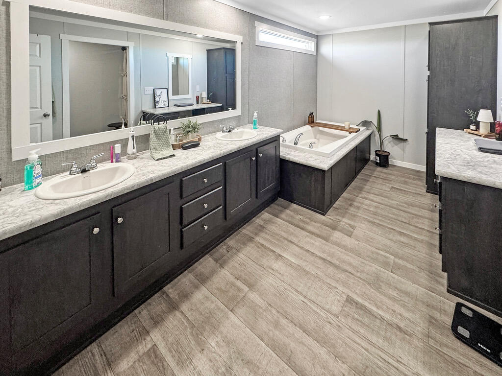 349 Private Road, Unit 243P Seminole, TX 79360 - Photo 10 of 24 a bathroom with a sink double vanity granite and a mirror