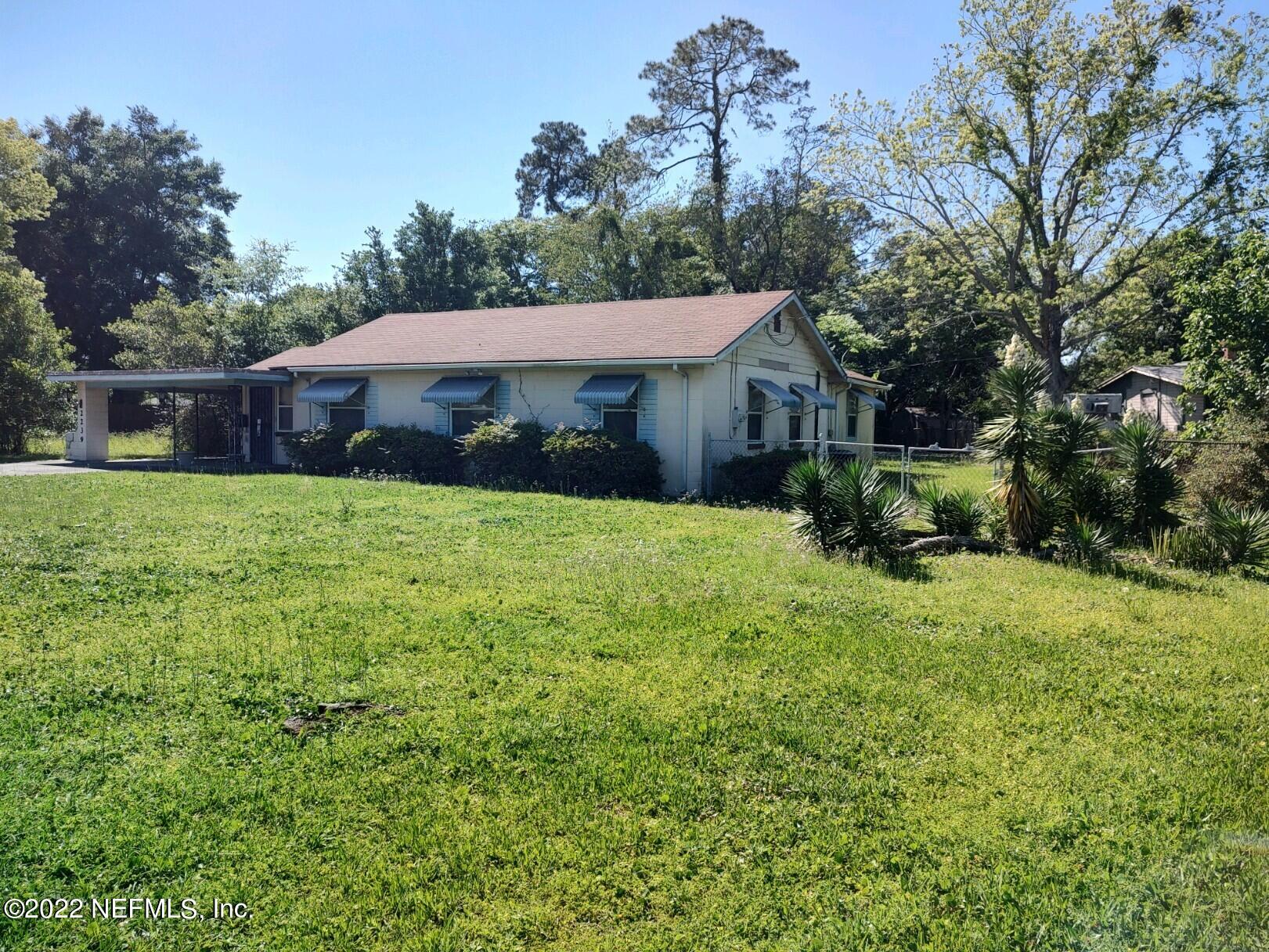 2239 Cato Road Jacksonville, FL 32207 - Photo 3 of 13 a view of a house with a yard and potted plants