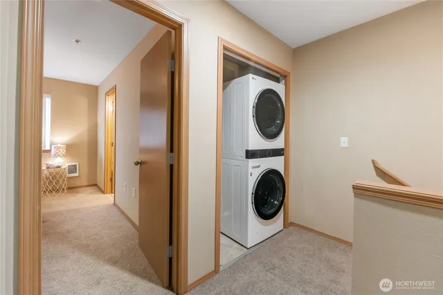 a view of a hallway with washer and dryer
