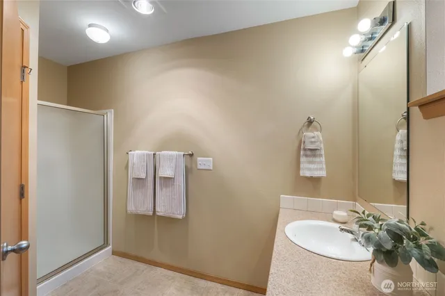 a bathroom with a sink vanity and mirror
