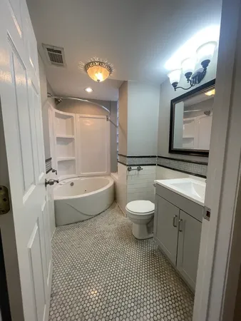 a bathroom with a sink a toilet and mirror