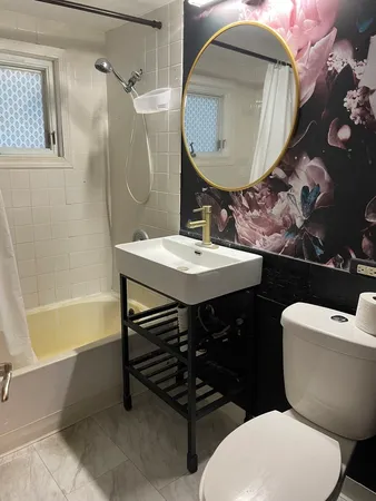 a bathroom with a sink a toilet and bathtub