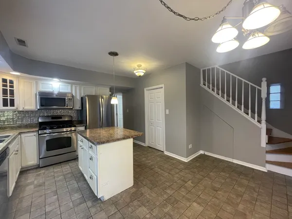 a kitchen with stainless steel appliances granite countertop a stove and a sink