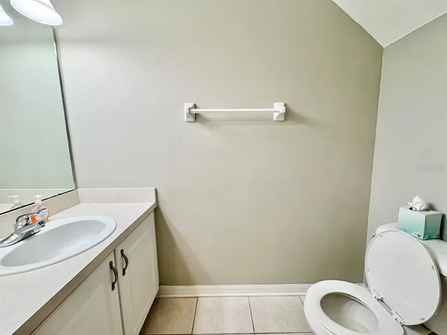 a bathroom with a sink vanity and toilet