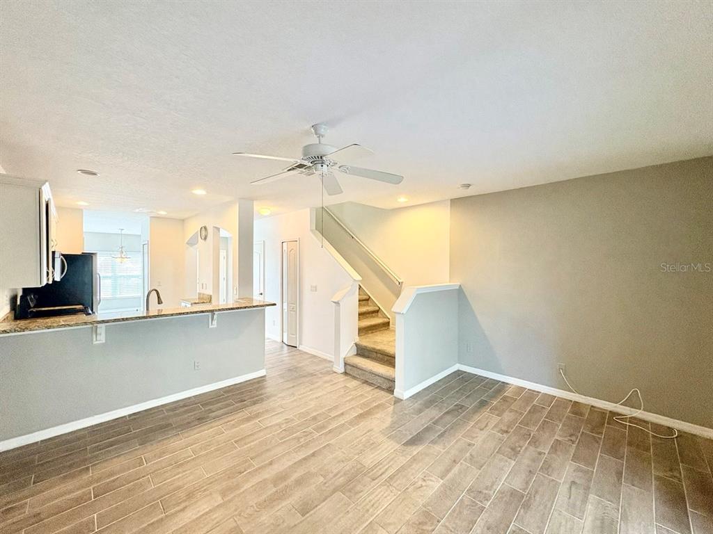 15619 Stable Run Drive Spring Hill, FL 34610 - Photo 13 of 28 a view of a kitchen with wooden floor and staircase