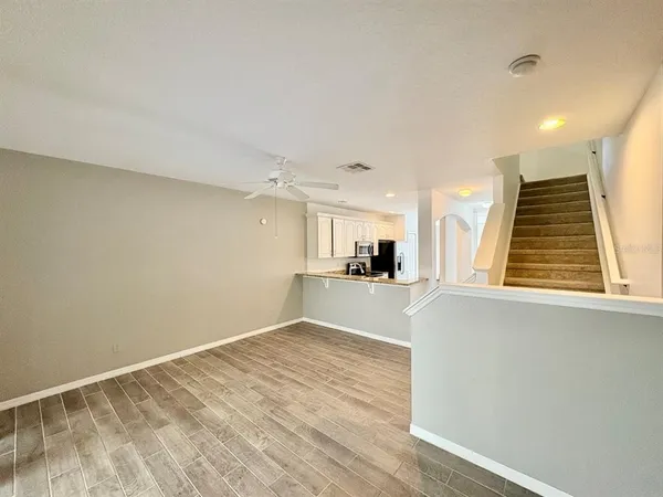 a view of a kitchen with wooden floor and a sink