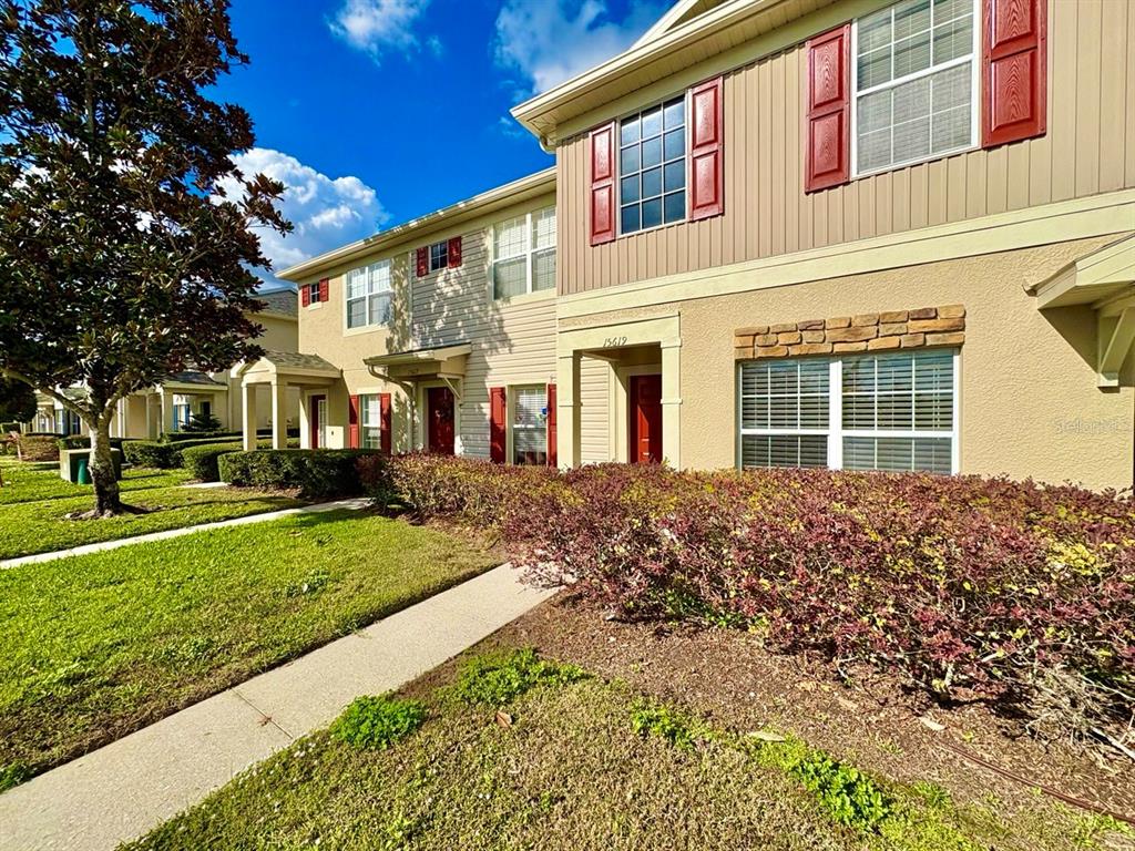 15619 Stable Run Drive Spring Hill, FL 34610 - Photo 3 of 28 front view of a house with a yard
