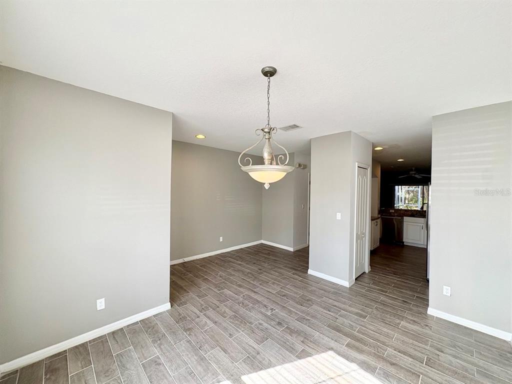 15619 Stable Run Drive Spring Hill, FL 34610 - Photo 5 of 28 a view of a kitchen with wooden floor and a hallway