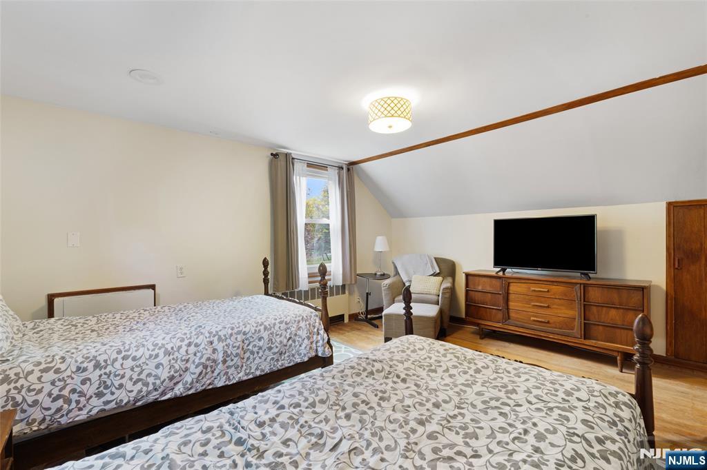 479 South Pleasant Avenue Ridgewood, NJ 07450 - Photo 13 of 26 a bedroom with a bed and a flat screen tv