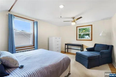 a bedroom with a bed couch and window