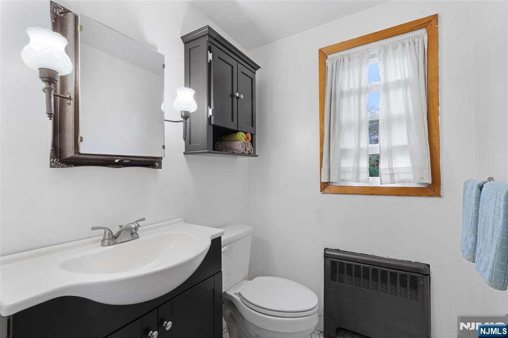 479 South Pleasant Avenue Ridgewood, NJ 07450 - Photo 16 of 26 a bathroom with a toilet a sink and mirror
