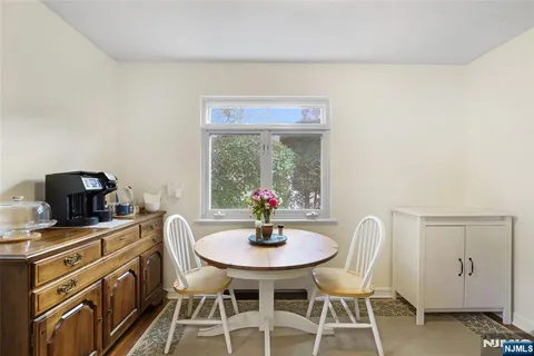 a view of a dining room with furniture and a window