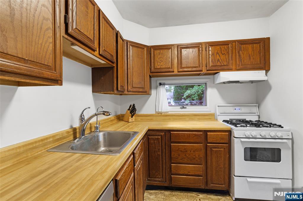 479 South Pleasant Avenue Ridgewood, NJ 07450 - Photo 8 of 26 a kitchen with a sink stove and cabinets