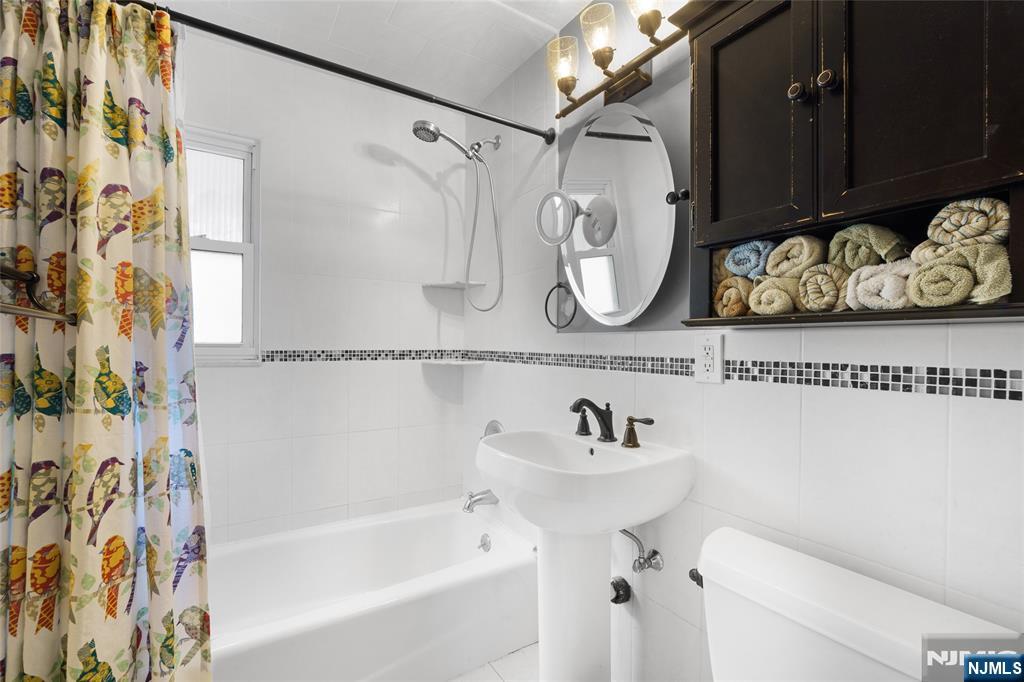 479 South Pleasant Avenue Ridgewood, NJ 07450 - Photo 9 of 26 a bathroom with a sink and a bathtub