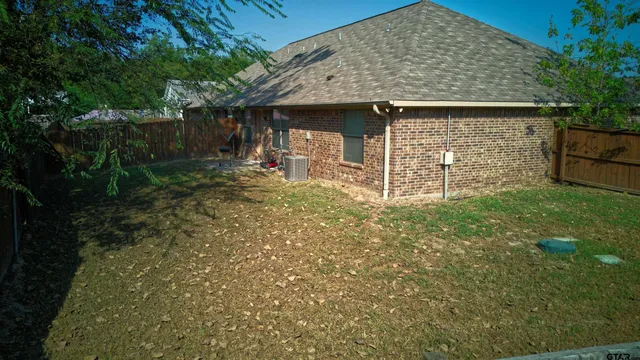 a view of a house with yard and sitting area