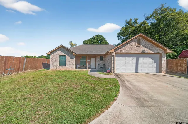 a view of a house with a yard and garage