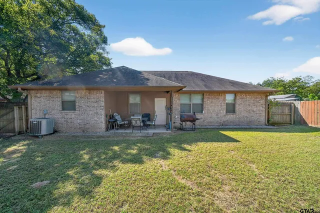 a view of a house with swimming pool and a yard