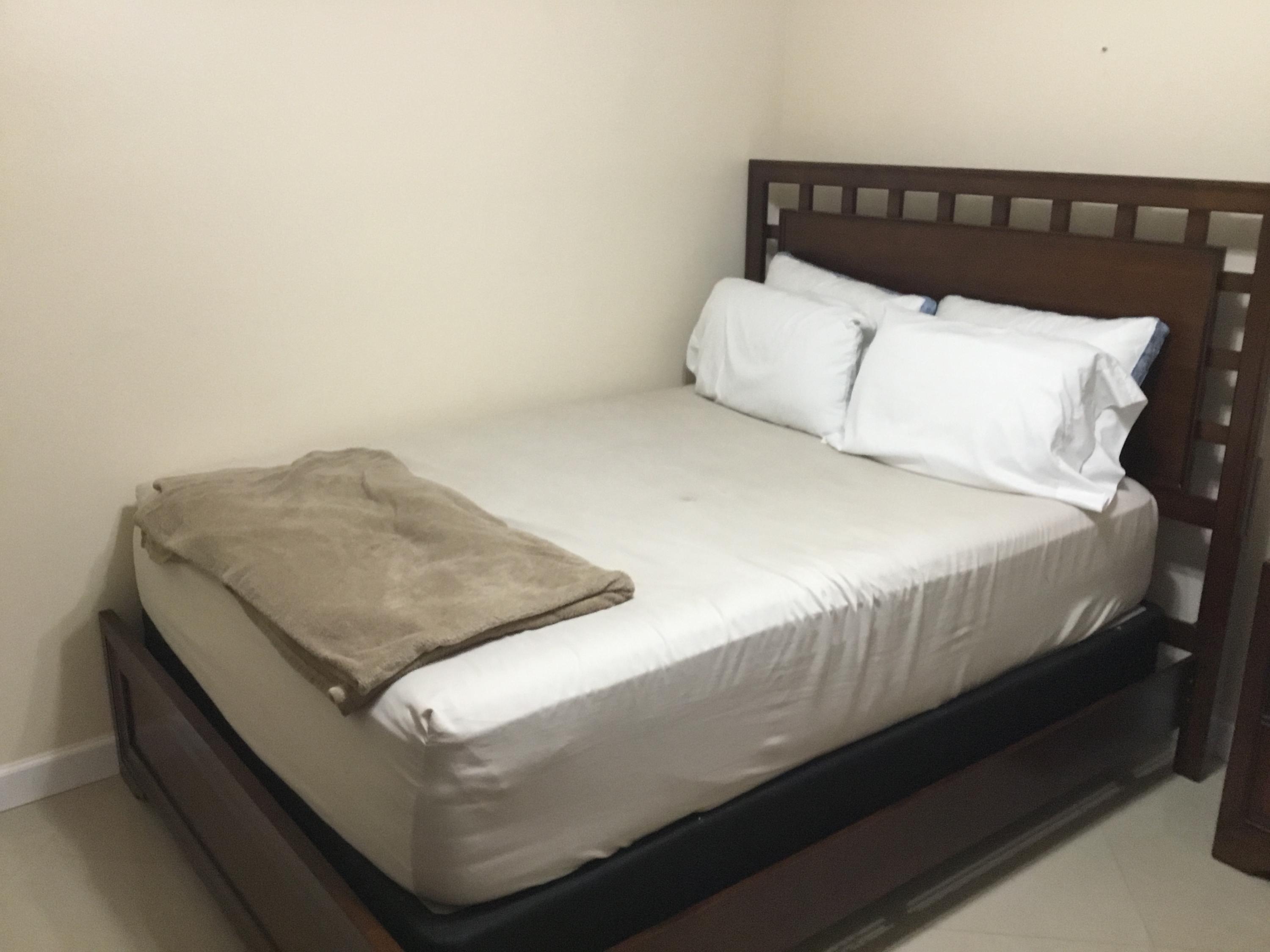 906 Southwest 9th St Circle, Unit 106 Boca Raton, FL 33486 - Photo 15 of 26 a bedroom with a bed and a night stand