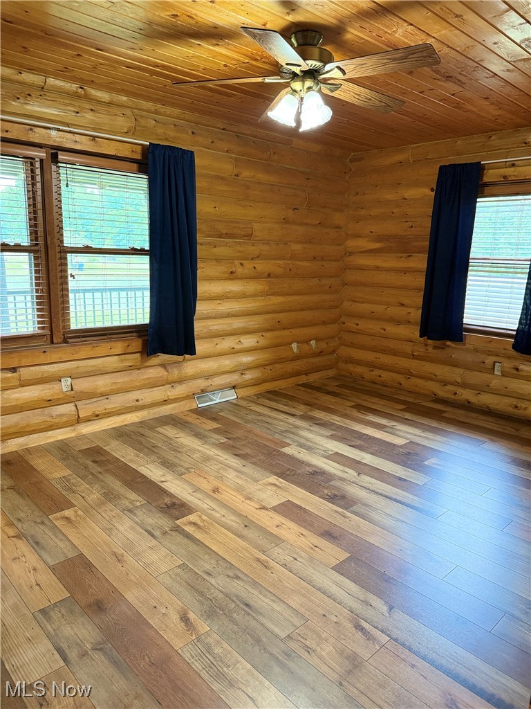 15180 Stoltz Road Diamond, OH 44412 - Photo 43 of 48 Empty room featuring a ceiling fan, hardwood / wood-style floors, plenty of natural light, and wooden ceiling