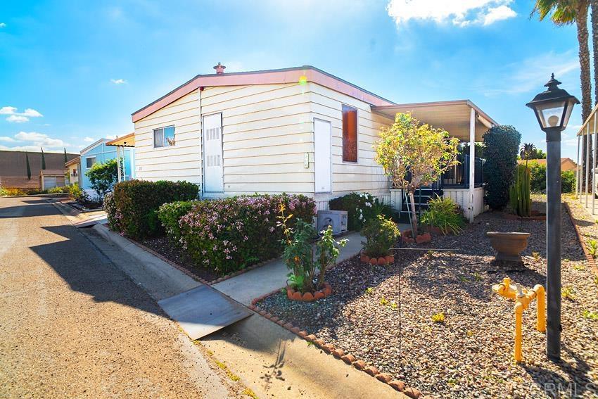 8712 North Magnolia, Unit 218 Santee, CA 92071 - Photo 1 of 1 a front view of a house with garden