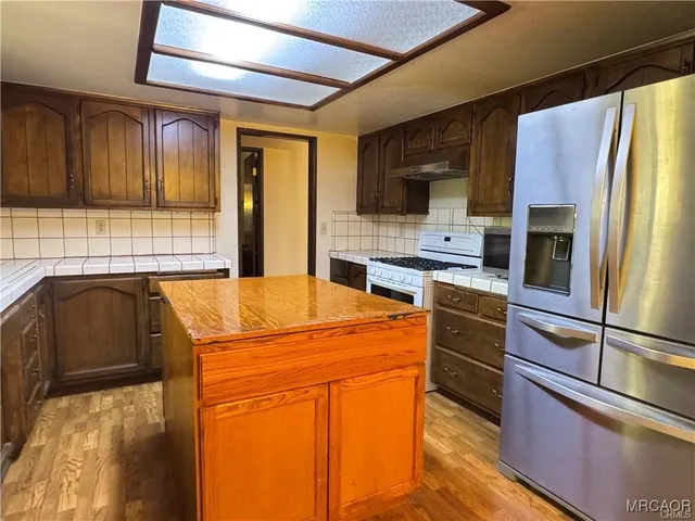a view of a room with wooden floor closet and fan