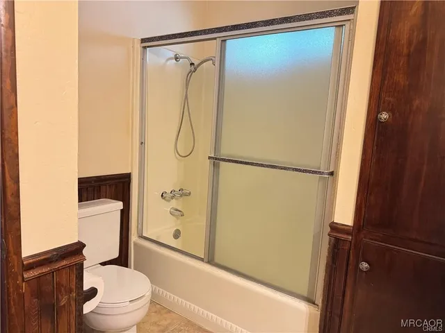 a view of balcony with wooden floor and seating