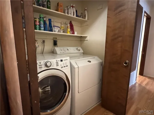 a view of a house with a yard covered with snow in the forest
