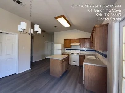 a kitchen with a stove a sink and a refrigerator