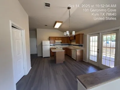 a view of a hallway with wooden floor and a ceiling fan