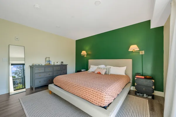 a bedroom with a bed and a dresser