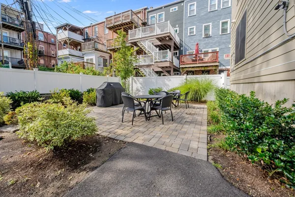a view of a patio with table and chairs and potted plants