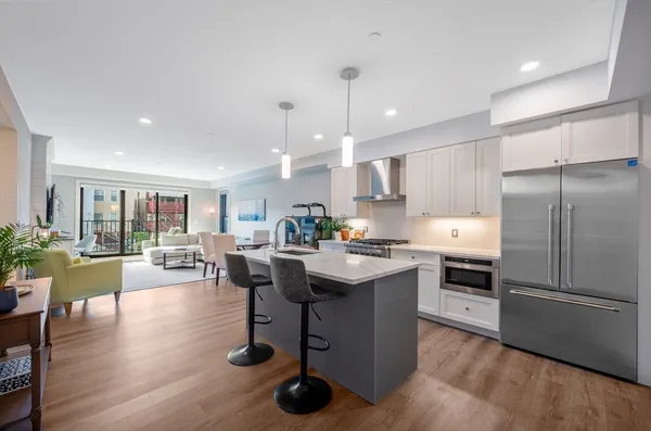 a kitchen with counter top space a sink appliances and cabinets
