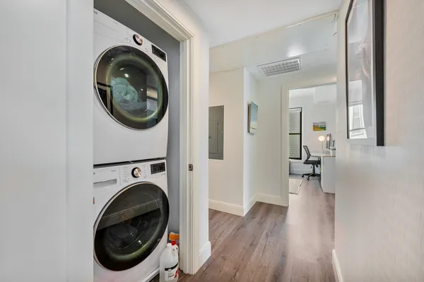 a view of a hallway with washer and dryer