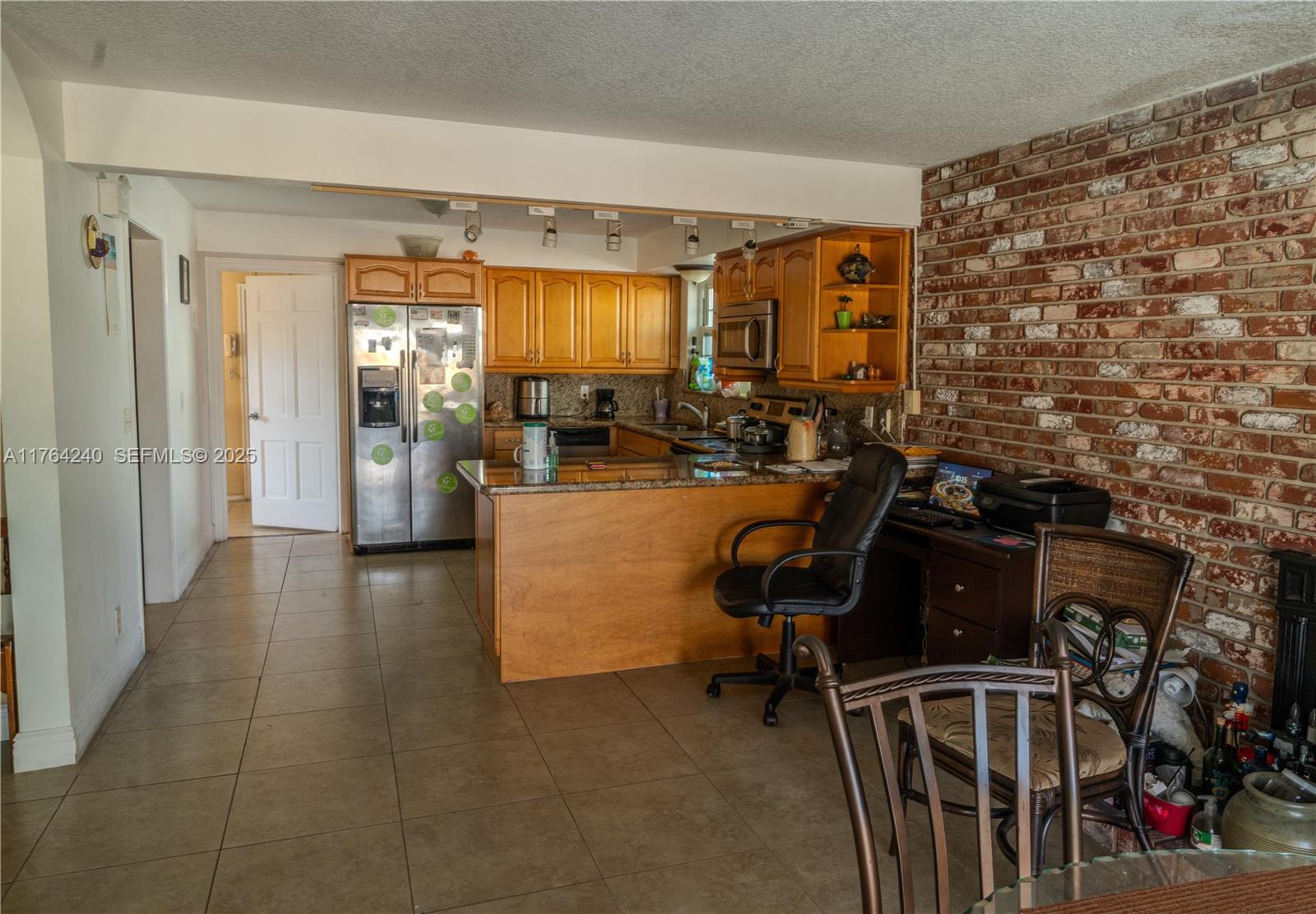 315 Southwest 12th Avenue Boynton Beach, FL 33435 - Photo 13 of 37 a view of a workspace with furniture and a window