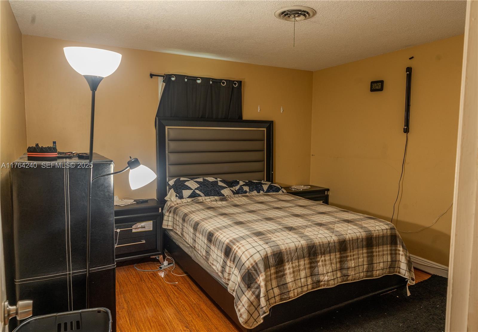 315 Southwest 12th Avenue Boynton Beach, FL 33435 - Photo 19 of 37 a bedroom with a bed and a chandelier