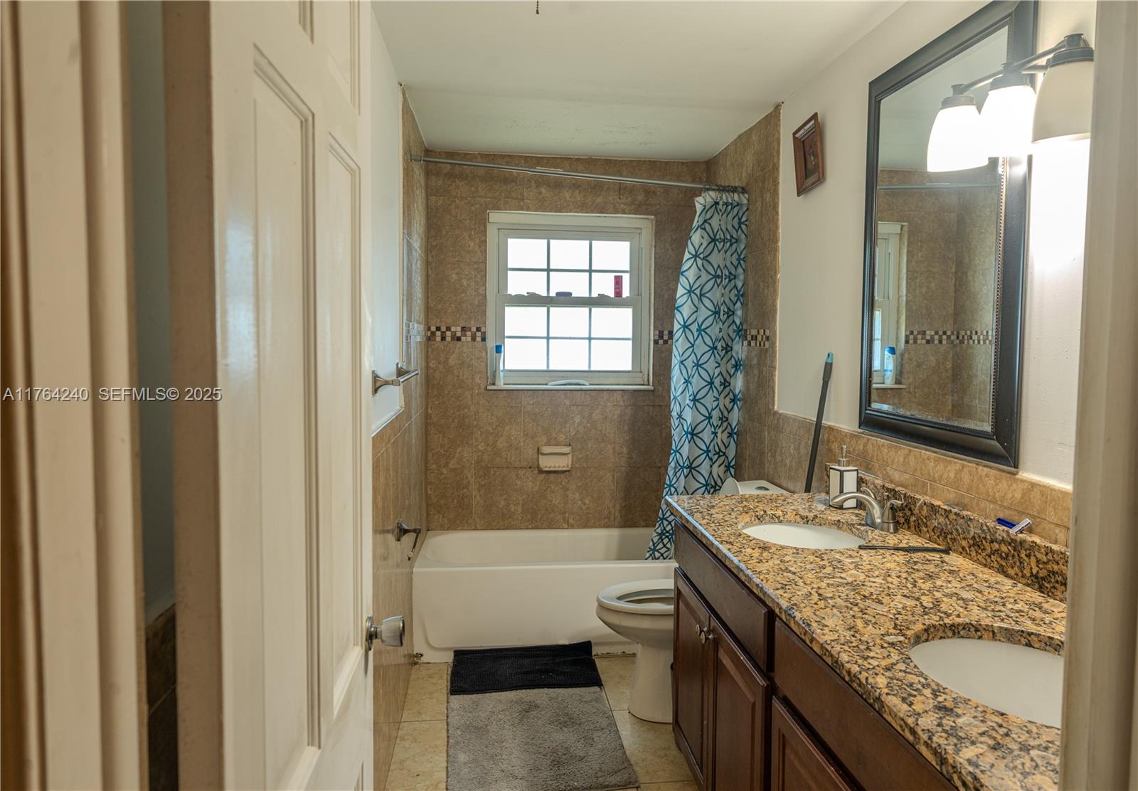 315 Southwest 12th Avenue Boynton Beach, FL 33435 - Photo 20 of 37 a bathroom with a granite countertop sink toilet and shower