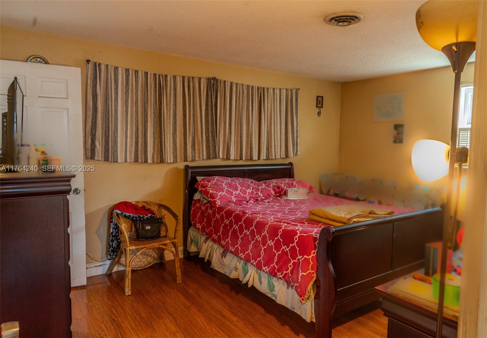 315 Southwest 12th Avenue Boynton Beach, FL 33435 - Photo 23 of 37 a bed room with a bed and a chair