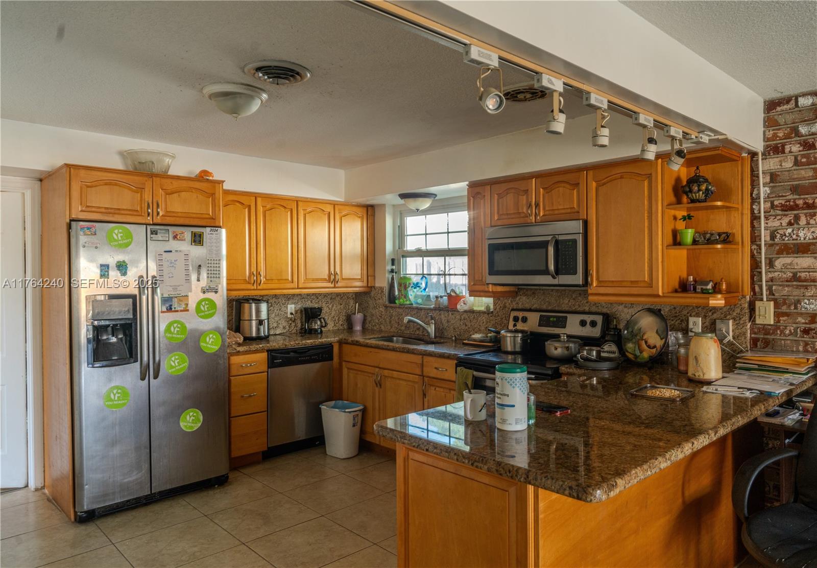 315 Southwest 12th Avenue Boynton Beach, FL 33435 - Photo 4 of 37 a kitchen with stainless steel appliances granite countertop a sink stove and refrigerator
