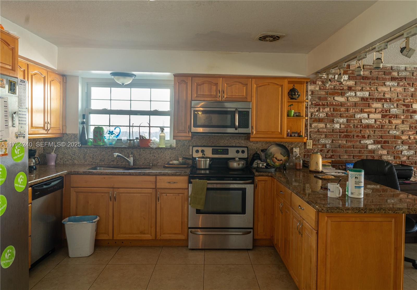 315 Southwest 12th Avenue Boynton Beach, FL 33435 - Photo 6 of 37 a kitchen with stainless steel appliances granite countertop a stove a sink and a microwave