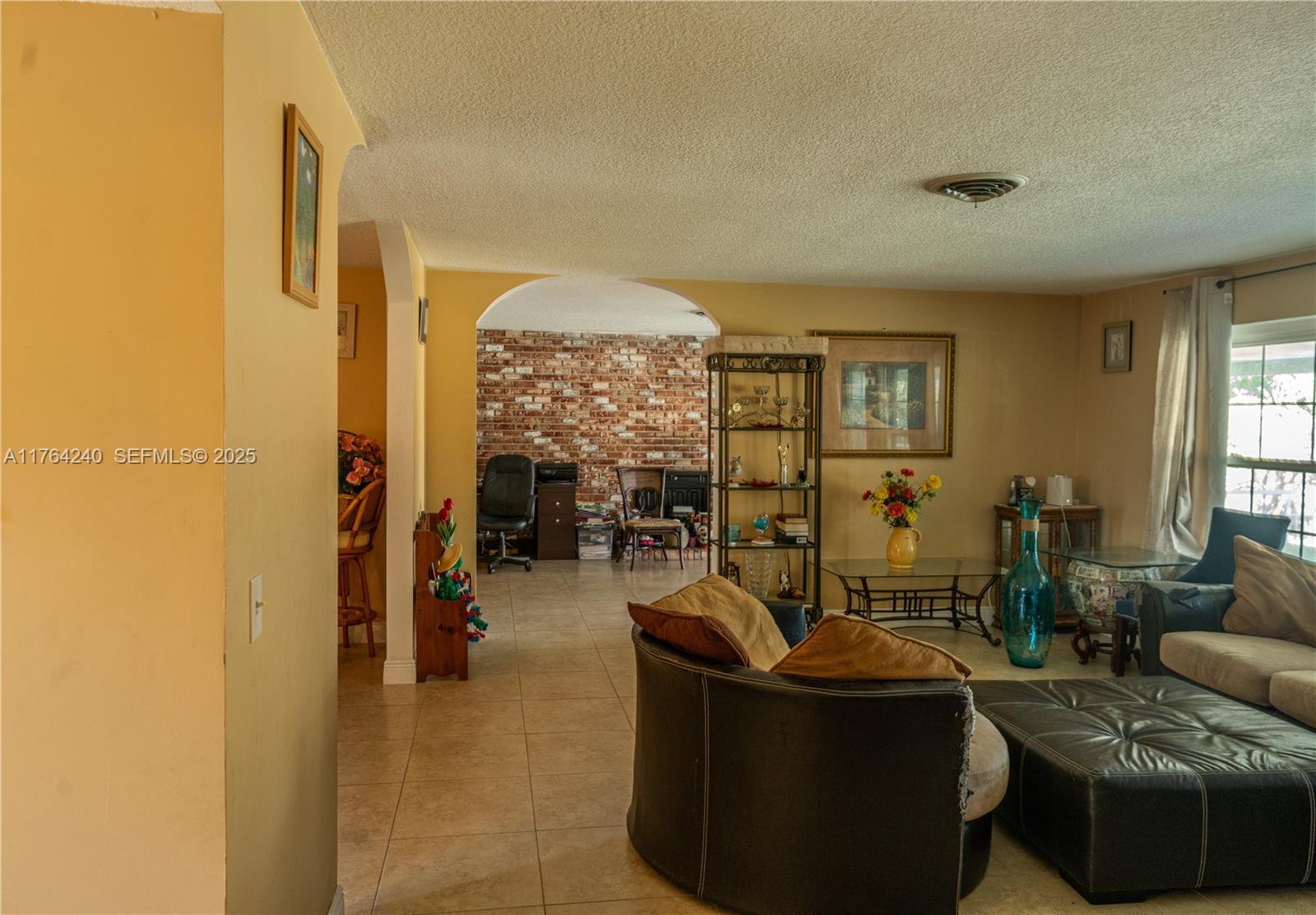 315 Southwest 12th Avenue Boynton Beach, FL 33435 - Photo 9 of 37 a living room with furniture and a large window