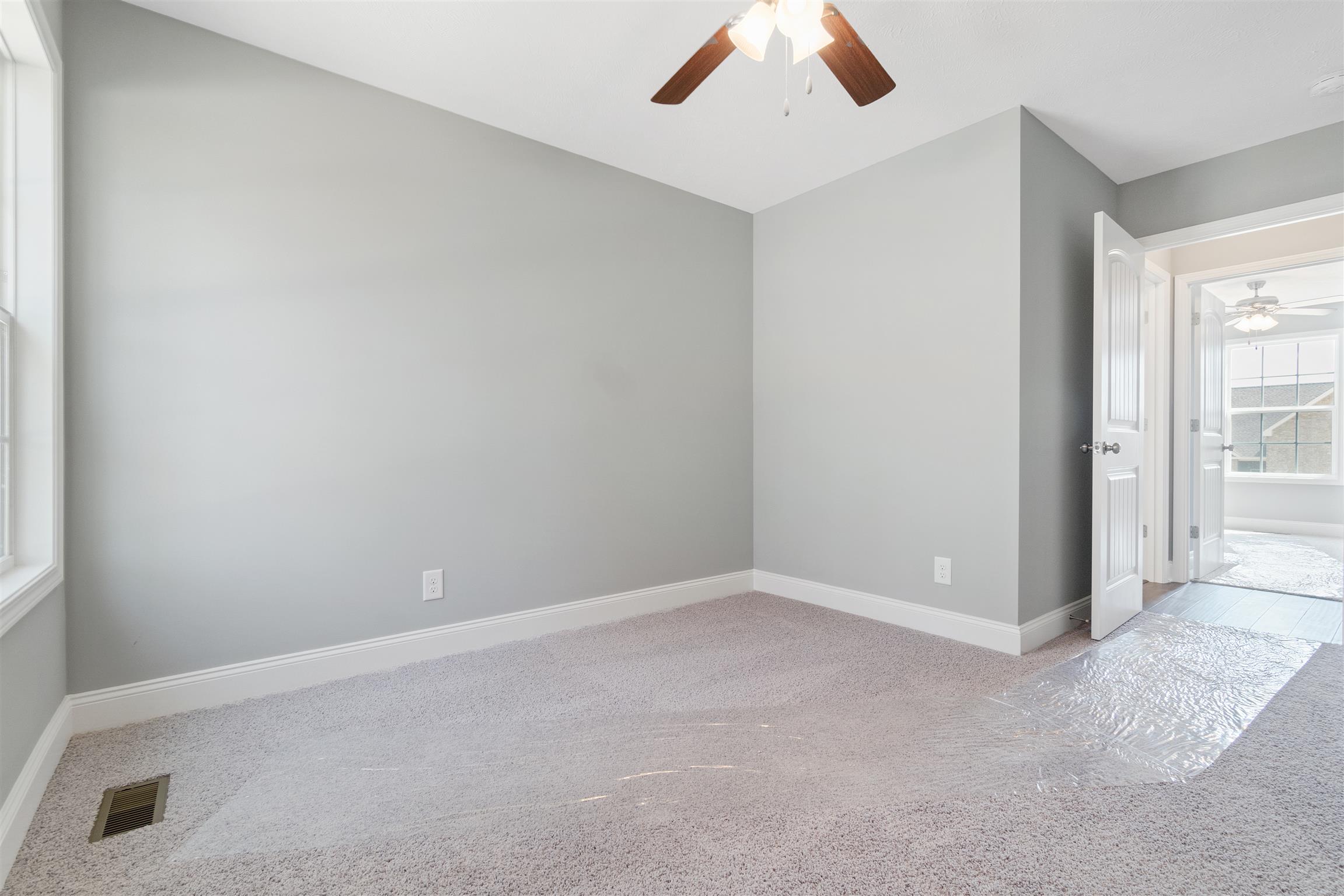 177 Fieldstone Lane Springfield, TN 37172 - Photo 16 of 27 an empty room with chandelier fan and windows